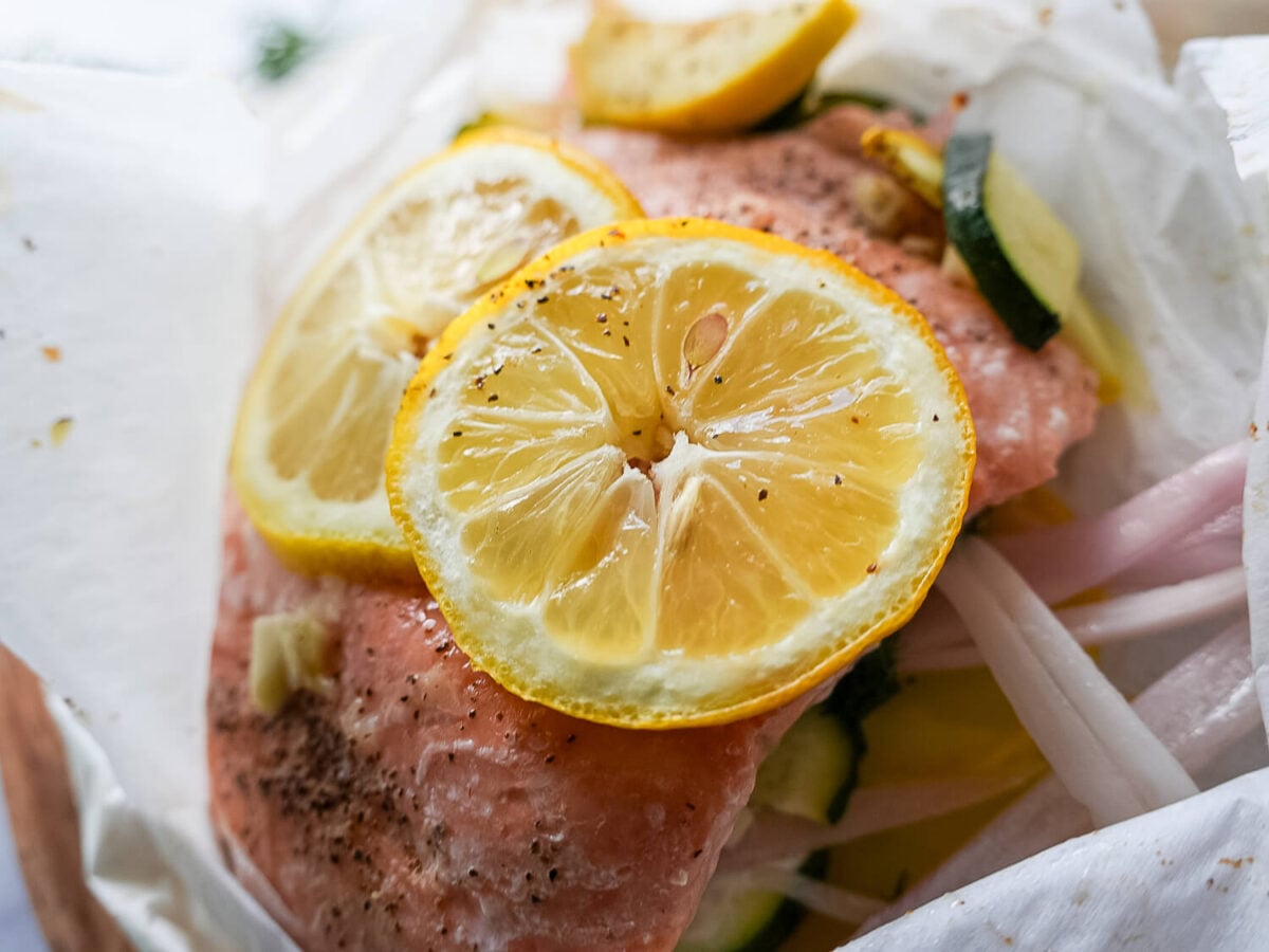 Close up photo of Salmon en Papillote - Salmon in Parchment Paper with a lemon on top