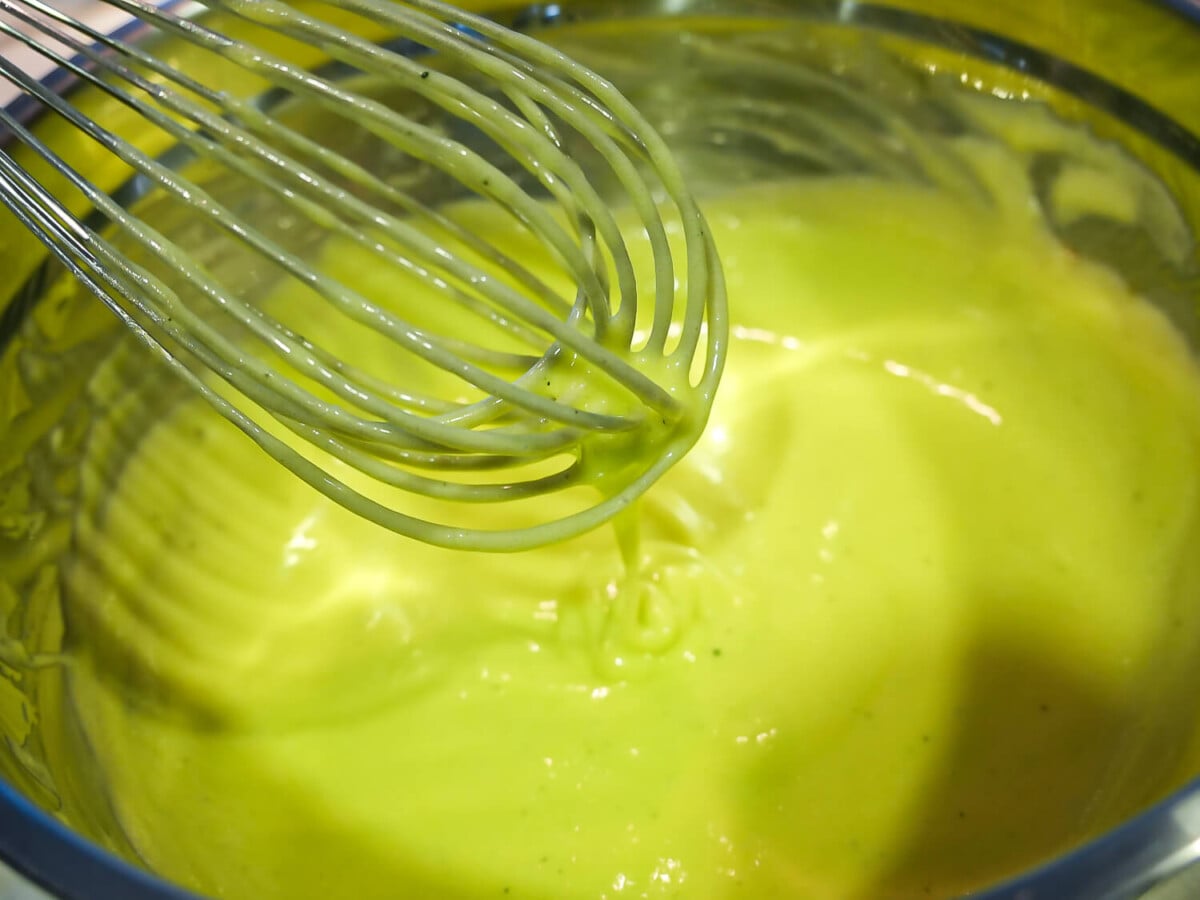 Close up photo of lime curd being whisked together