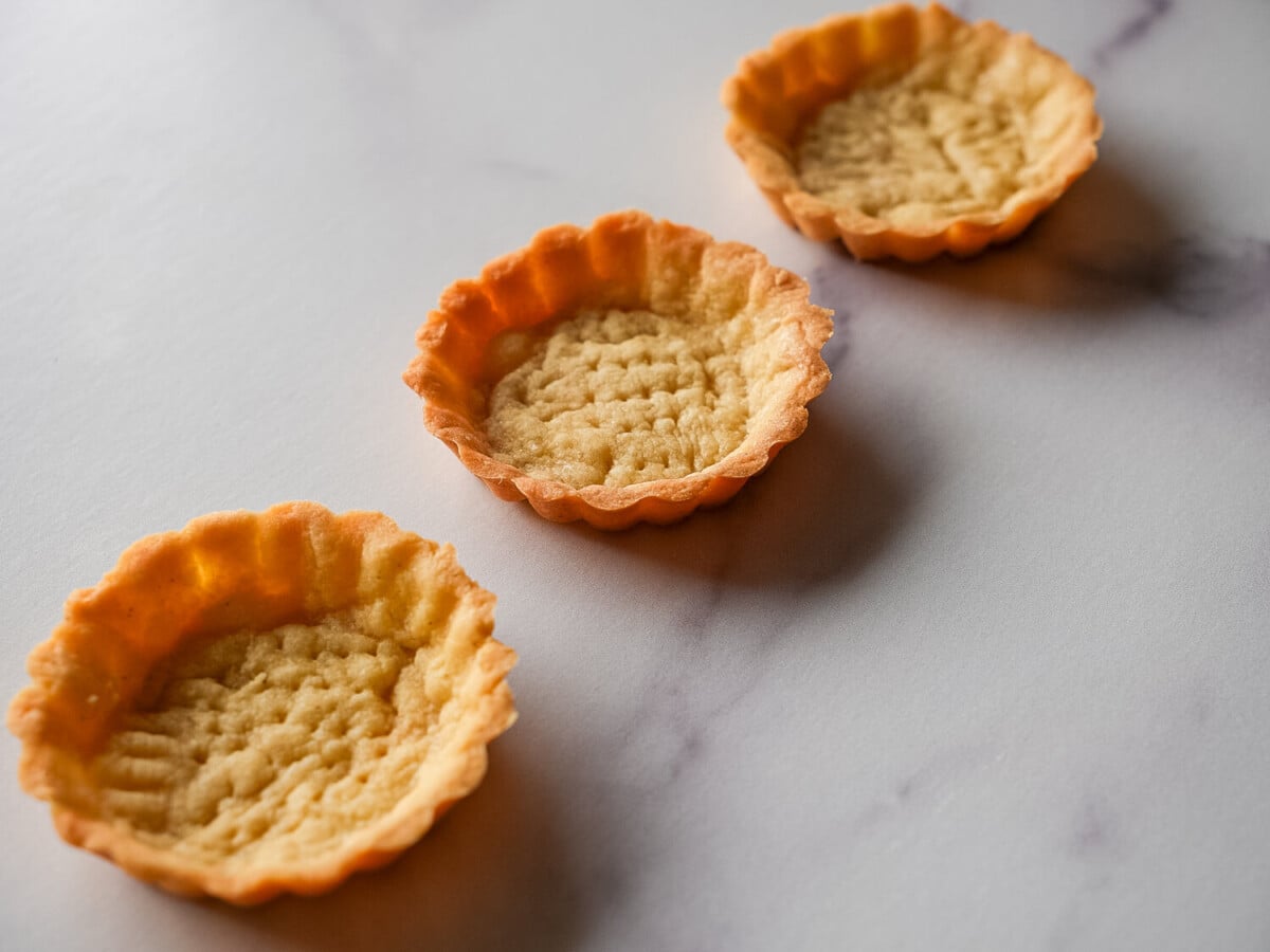 Photo of mini Pâte Sucrée tarts after baking