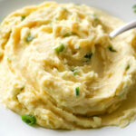 close up photo of Garlic Mashed Potatoes with a spoon