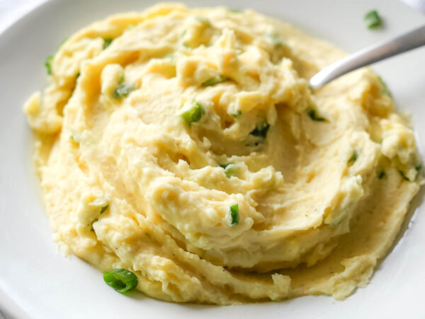 close up photo of Garlic Mashed Potatoes with a spoon