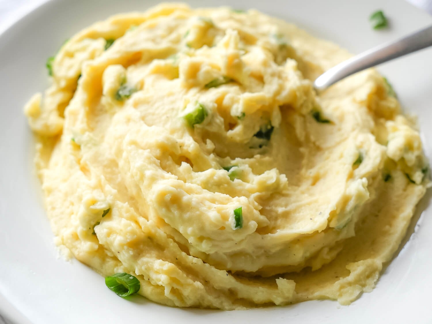 close up photo of Garlic Mashed Potatoes with a spoon
