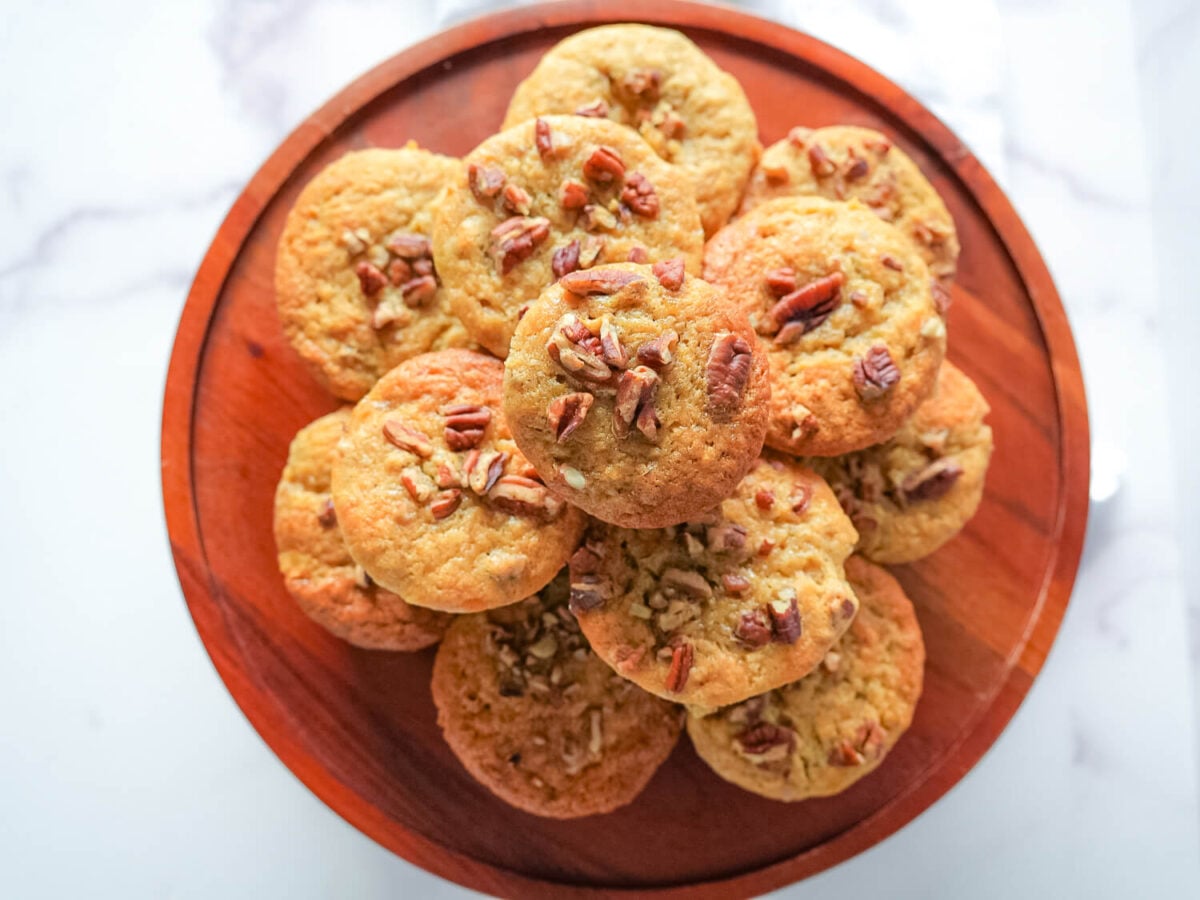overhead photo of banana nut muffins on a wooden tray