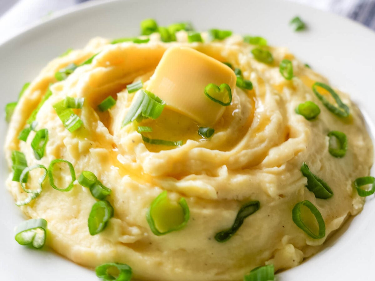 photo of Garlic Mashed Potatoes with butter and green onions on top