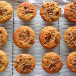 photo of a dozen baked banana nut muffins on a wire rack