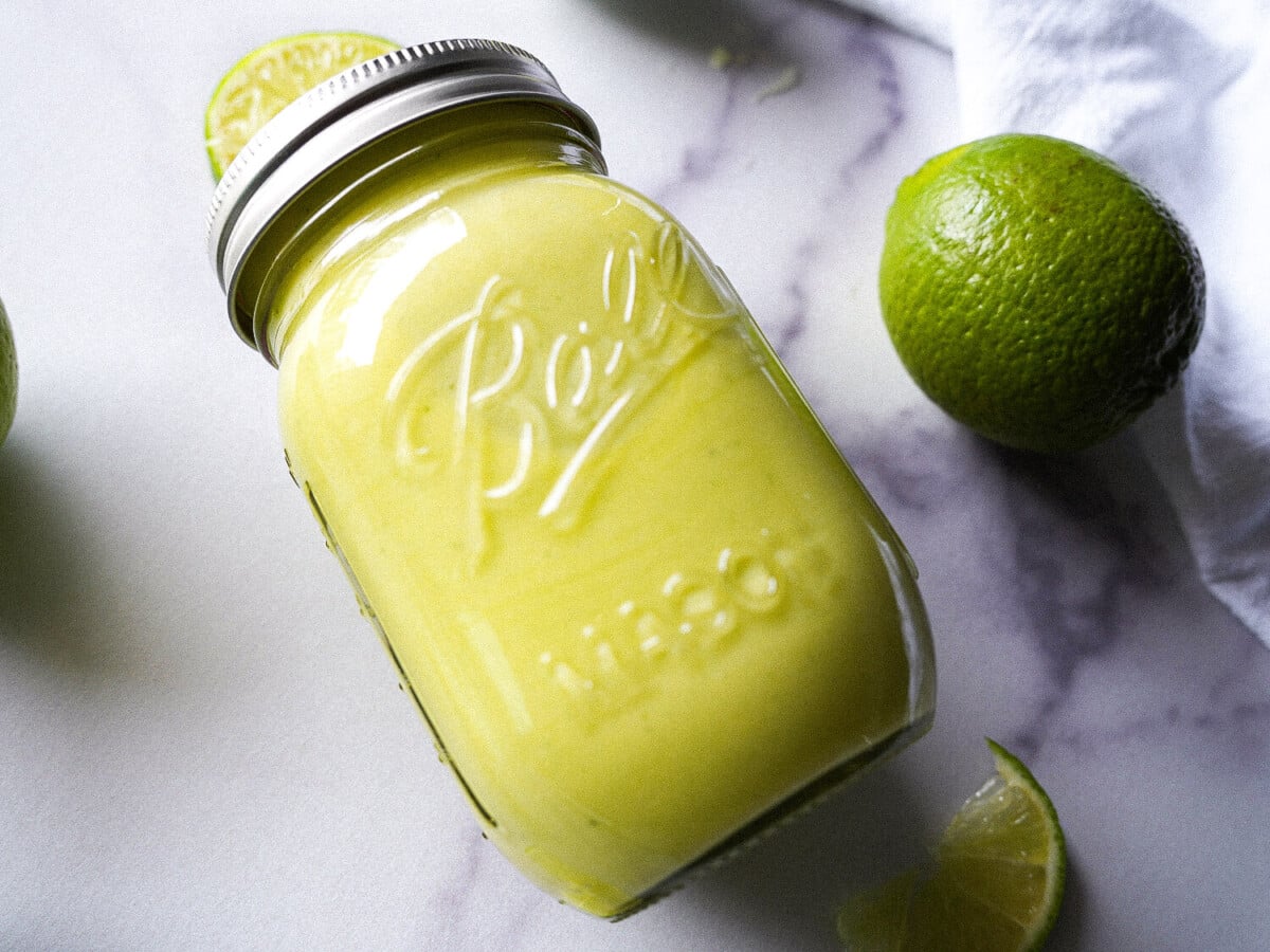 photo of lime curd in a mason jar on a marble surface