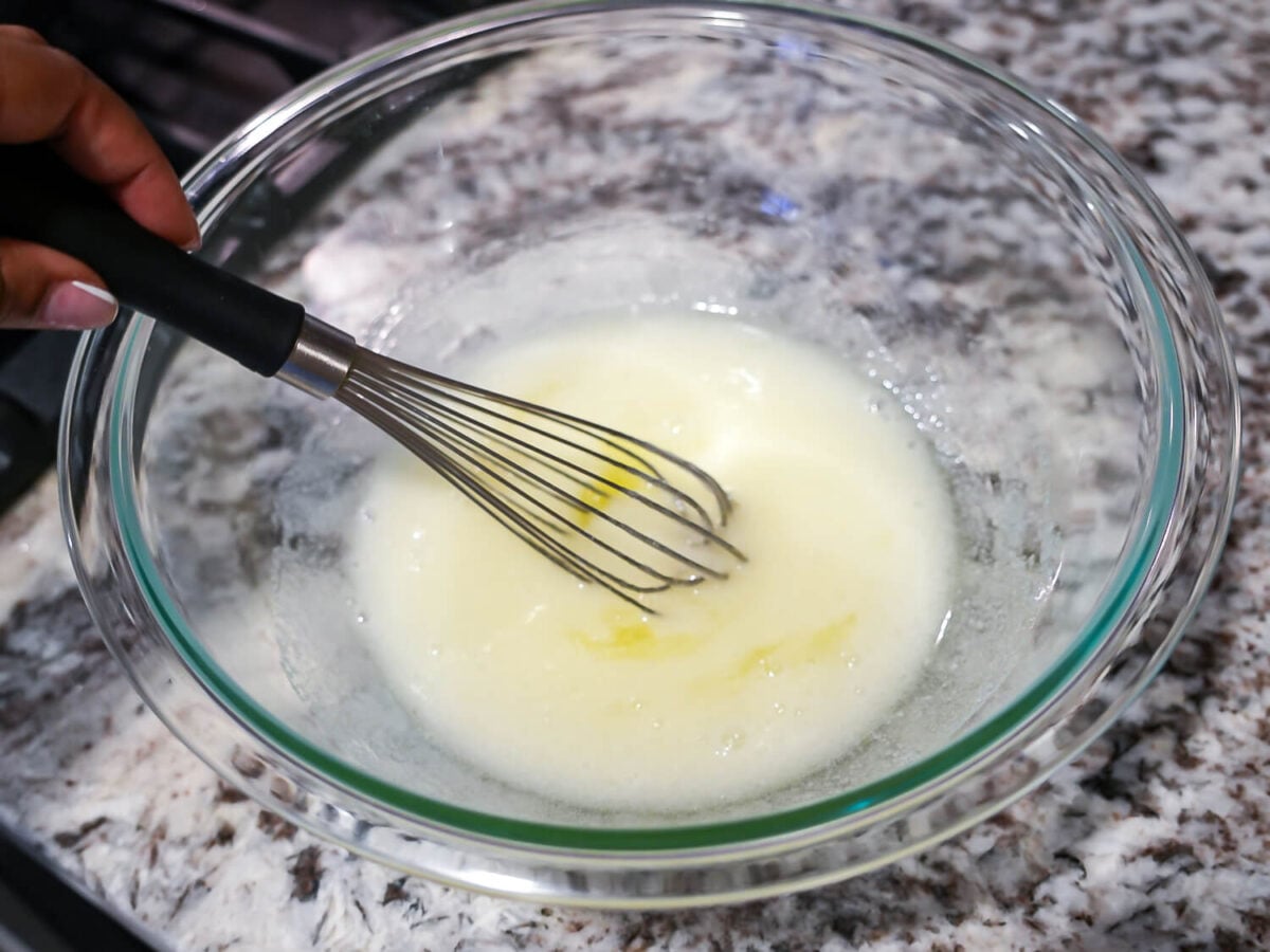 photo of mixing egg whites and sugar in a glass bowl