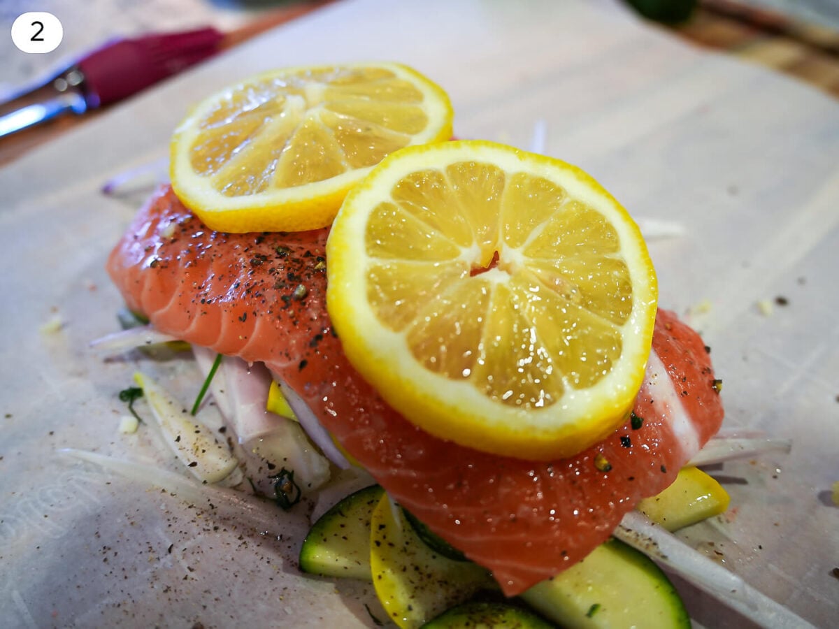 step 2 photo of seasoned salmon on top of a bed of vegetables