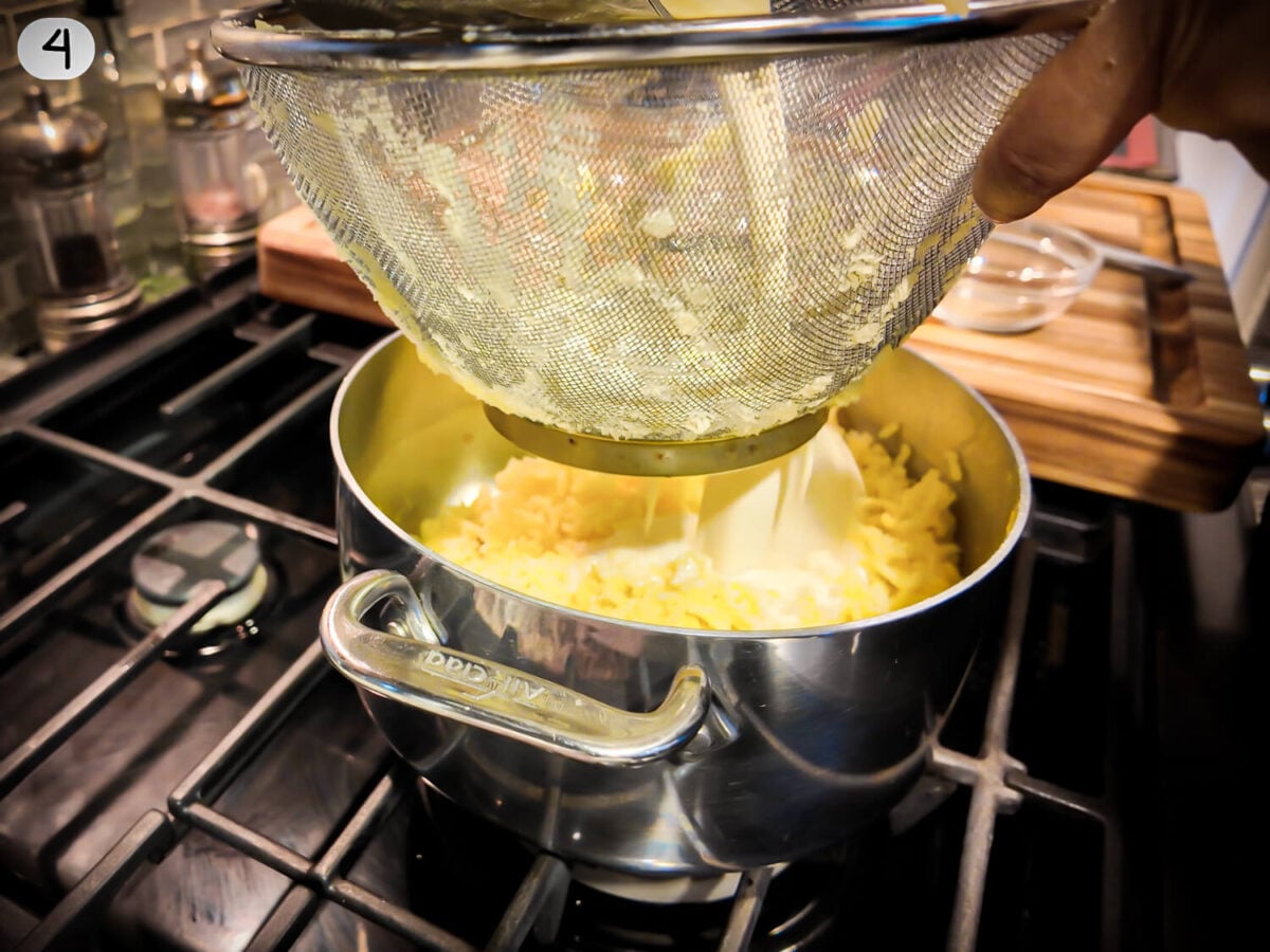 step 4 photo of straining cream onto potatoes