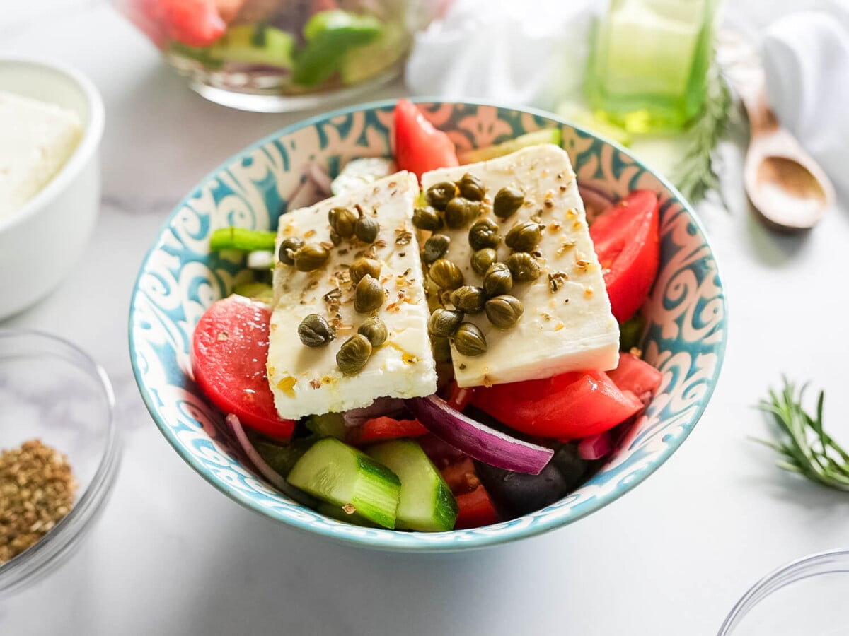 step four photo of greek salad with olive oli and capers on top-2