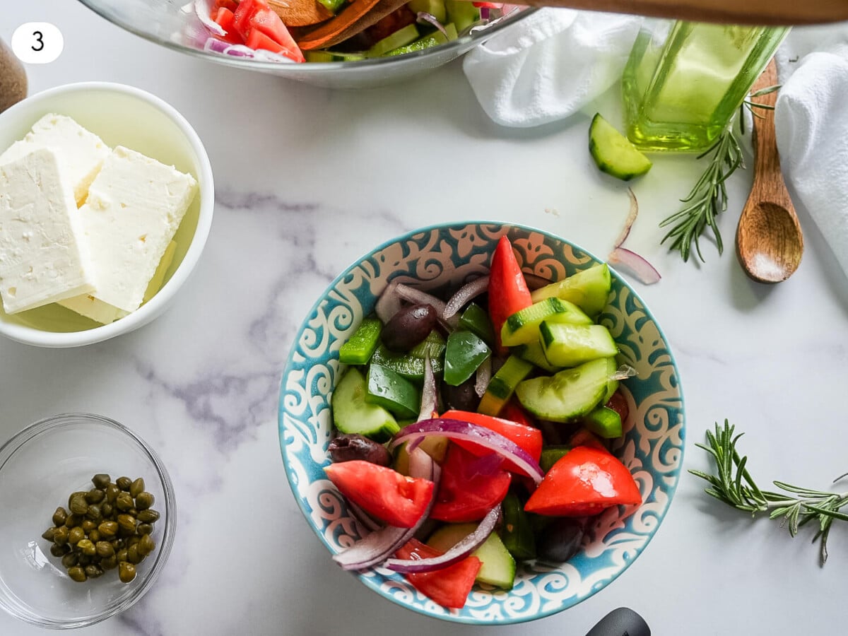 step three photo of a bowl of greek salad next to a bowl of sliced feta