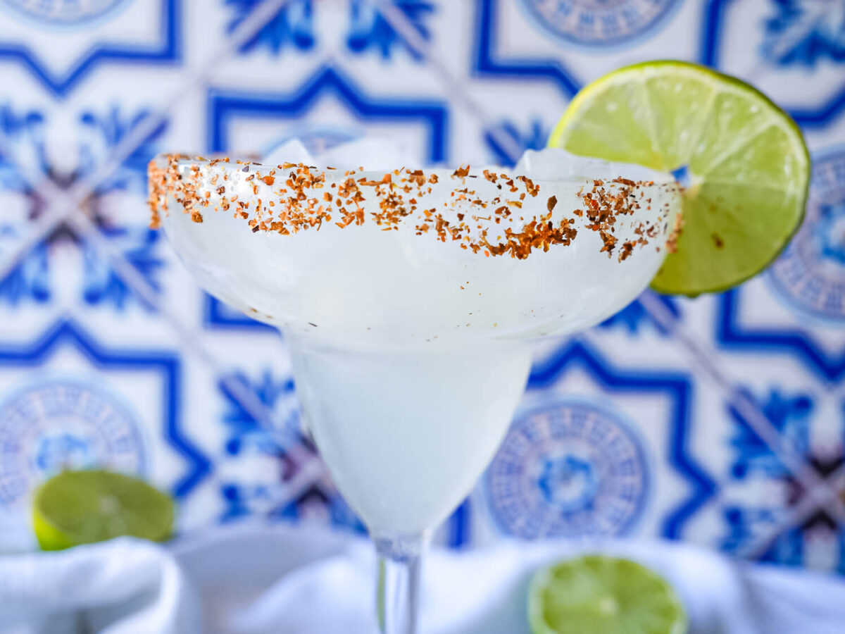 front view of a Classic Margarita in a margarita glass with Tajin rim