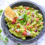 overhead photo of Guacamole and a tortilla chip