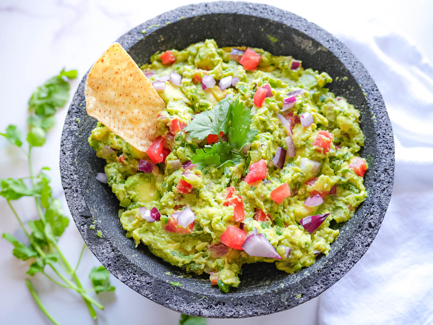 overhead photo of Guacamole and a tortilla chip