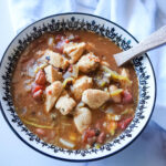 overhead photo of chicken chili in a black and white bowl