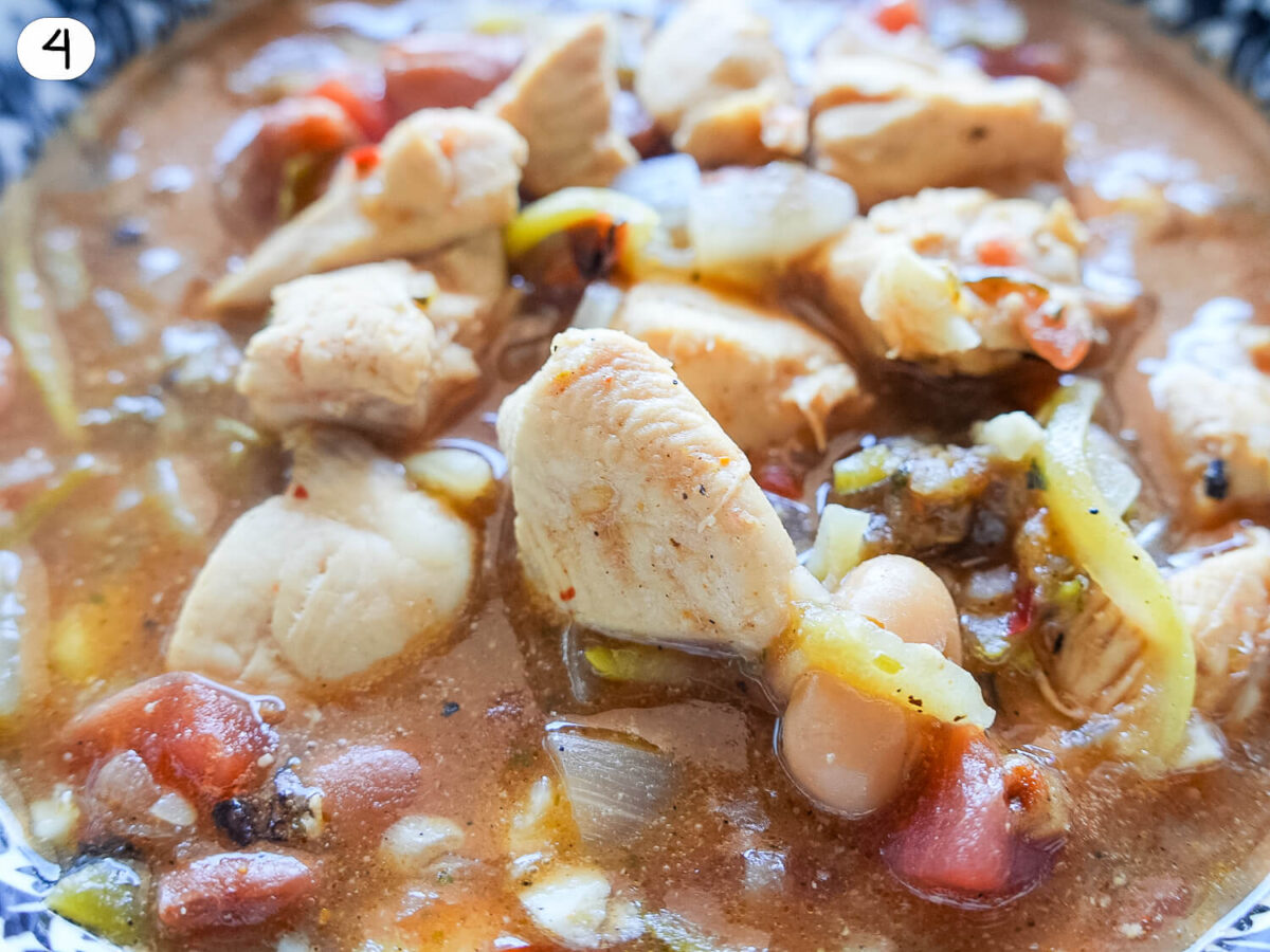 step four photo of cooked chicken chili in a bowl