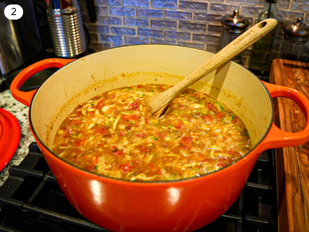 step two photo of adding vegetables and broth to a dutch oven
