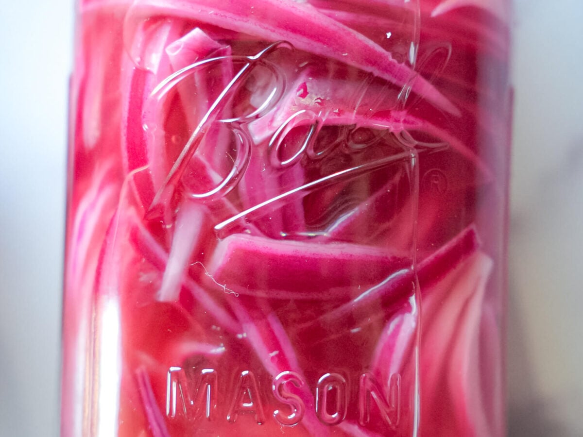 HERO zoomed in photo of pickled red onions in a mason jar