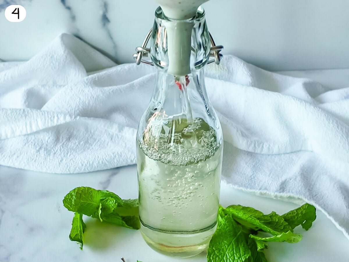 Step 4 photo of Mint Simple Syrup being poured into an airtight container through a funnel