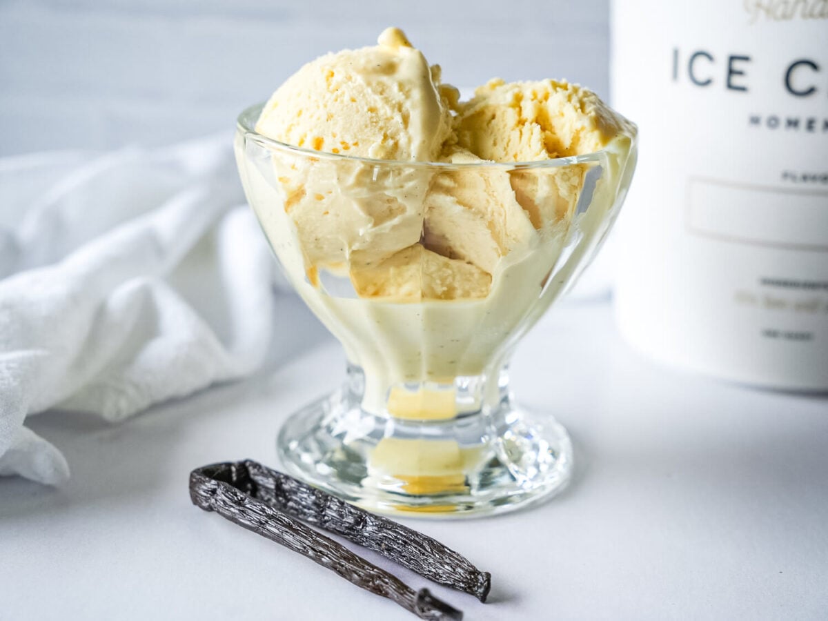 close photo of French Vanilla Ice Cream next to a vanilla bean
