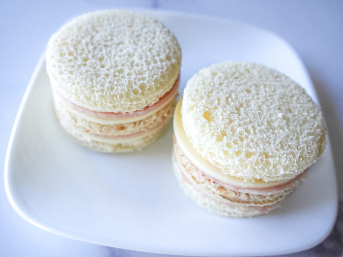 overhead photo of Ham & Cheese Tea Sandwiches on a white plate
