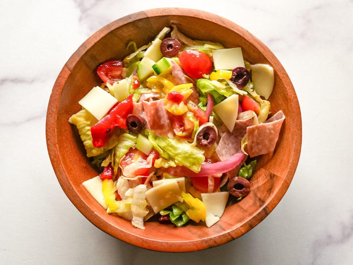 overhead photo of Italian chopped salad in a wooden bowl
