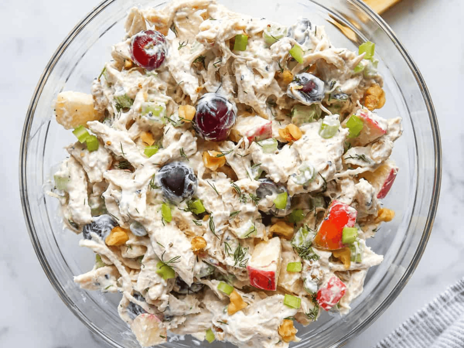 photo of a diary-free Healthy Greek Yogurt Chicken Salad in a glass bowl from Stacey at Garlic Salt and Lime