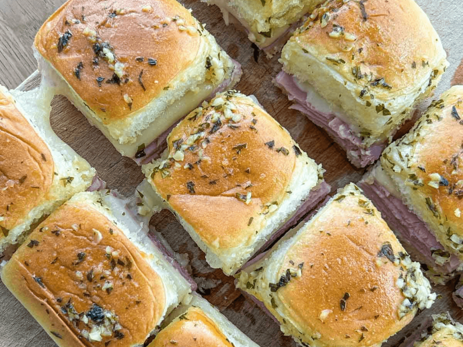 photo of ham and cheese sliders on a wooden cutting board by Trangs Kitchen Table