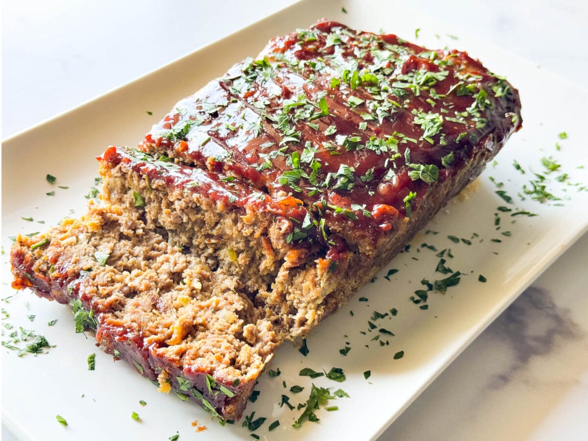 photo of meatloaf on a marble surface on a white plate
