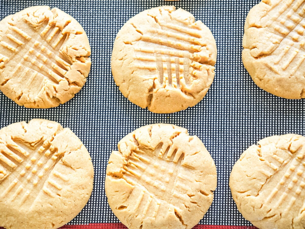 photo of peanut butter cookies resting on a silcone baking mat