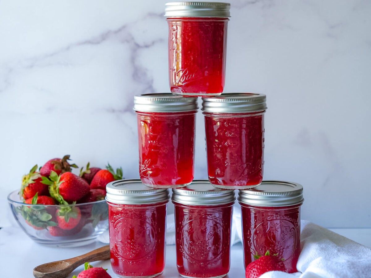 photo of six strawberry jam jars stacked on top of each other