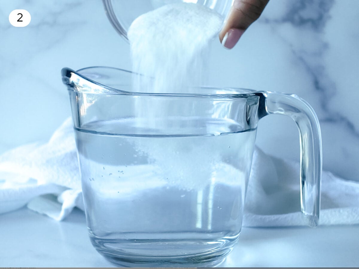 step 2 photo of adding salt to a cup of warm water