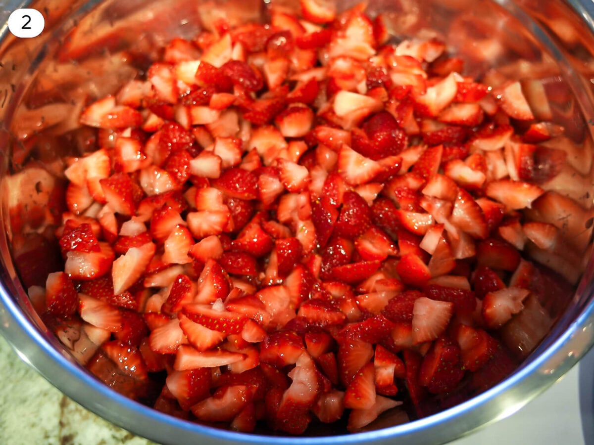 step 2 photo of cutting up strawberries into small pieces