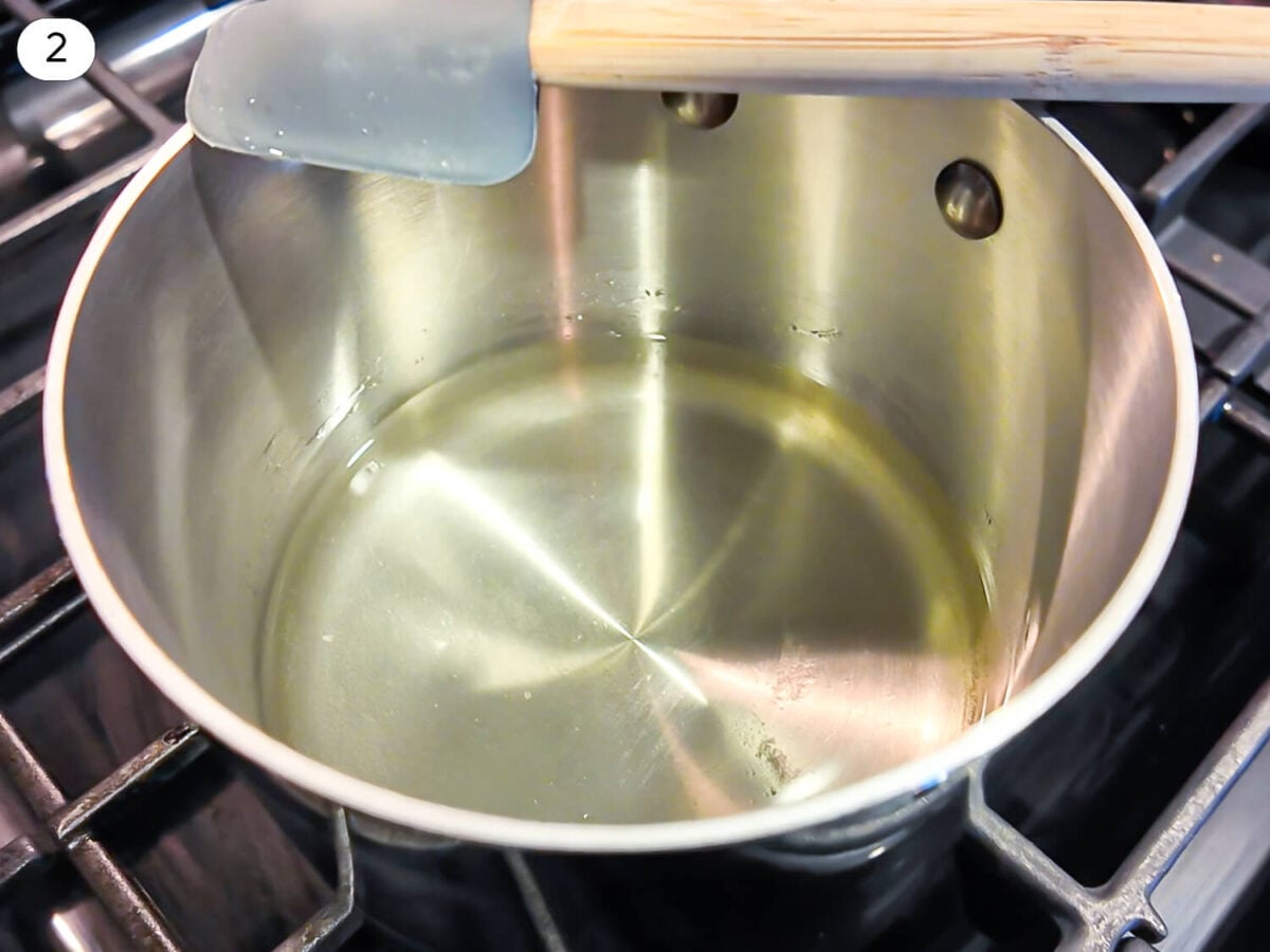 step 2 photo of sugar that was dissolved in water thats in a steel saucepan