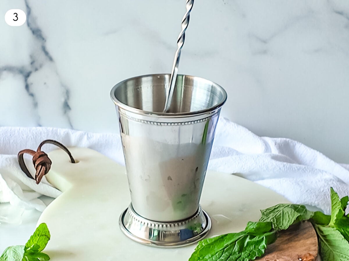 step 3 photo showing the Mint Julep being stirred with a cocktail spoon