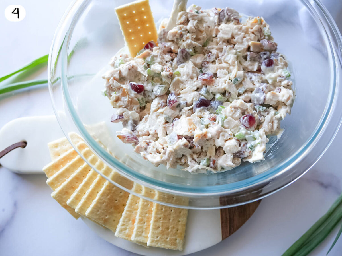 step four photo showing chicken salad in a bowl with crackers