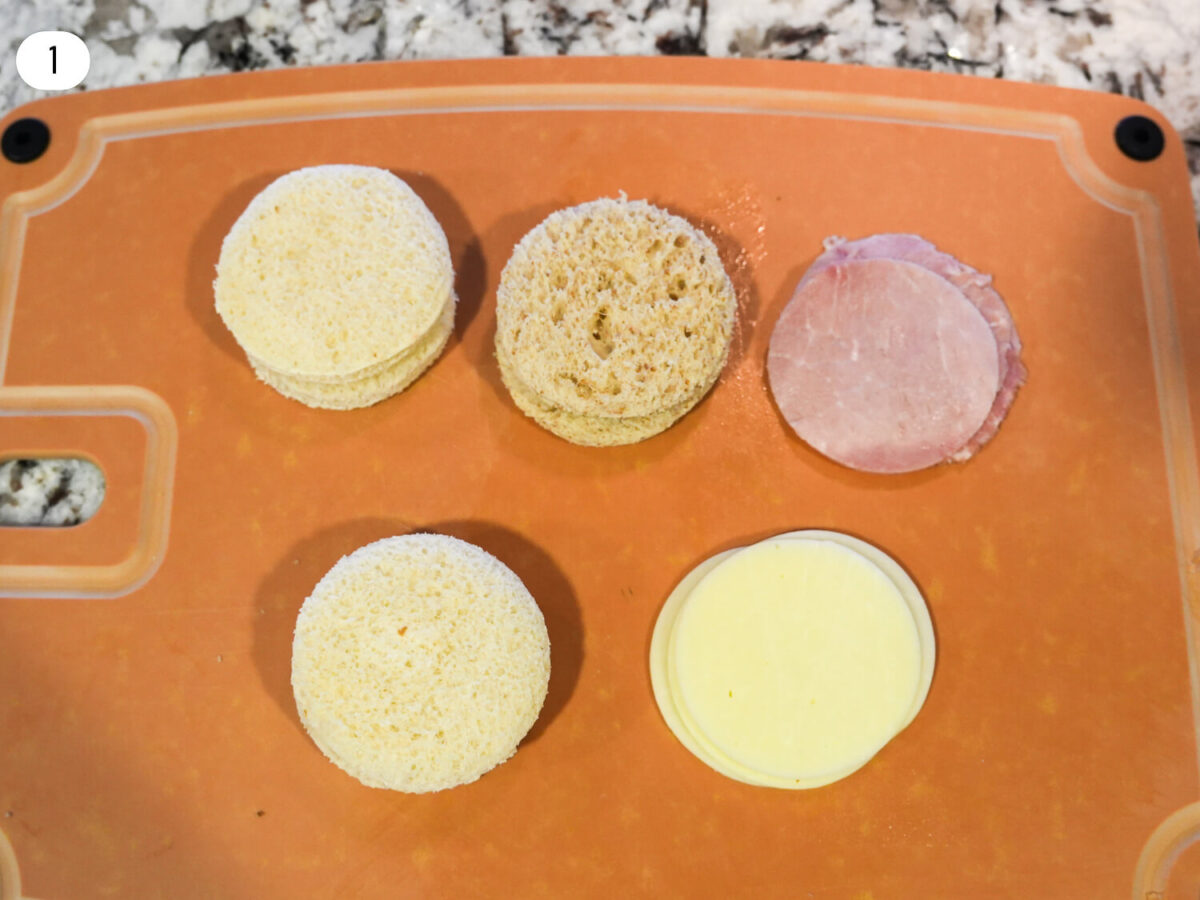 step one photo of Ham & Cheese Tea Sandwich ingredients sliced up