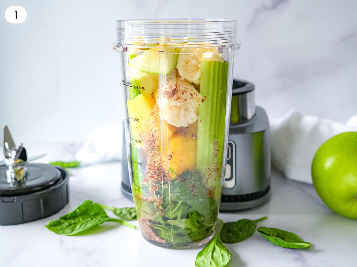 step one photo of Pineapple Spinach Smoothie ingredients in a blender before blending
