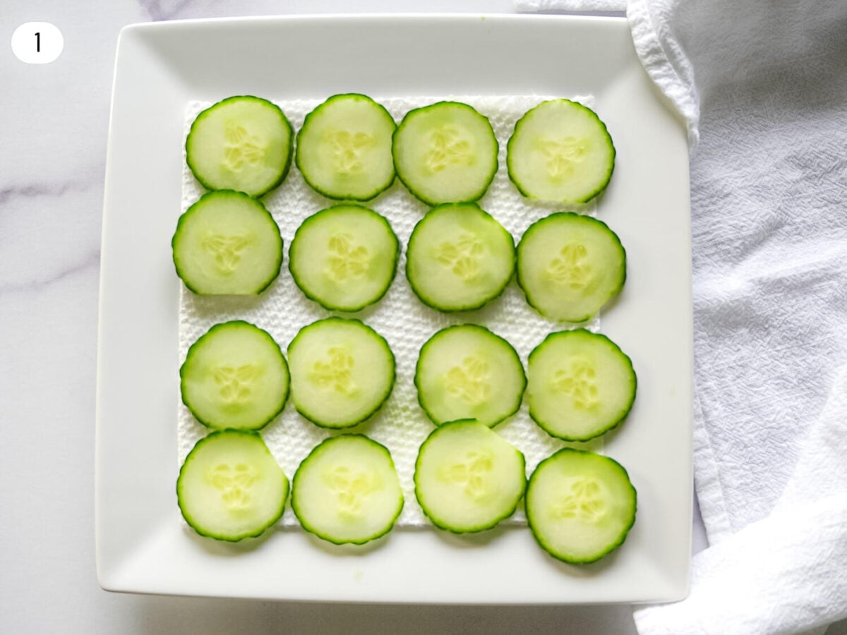 step one photo of sliced cucumbers being dried out