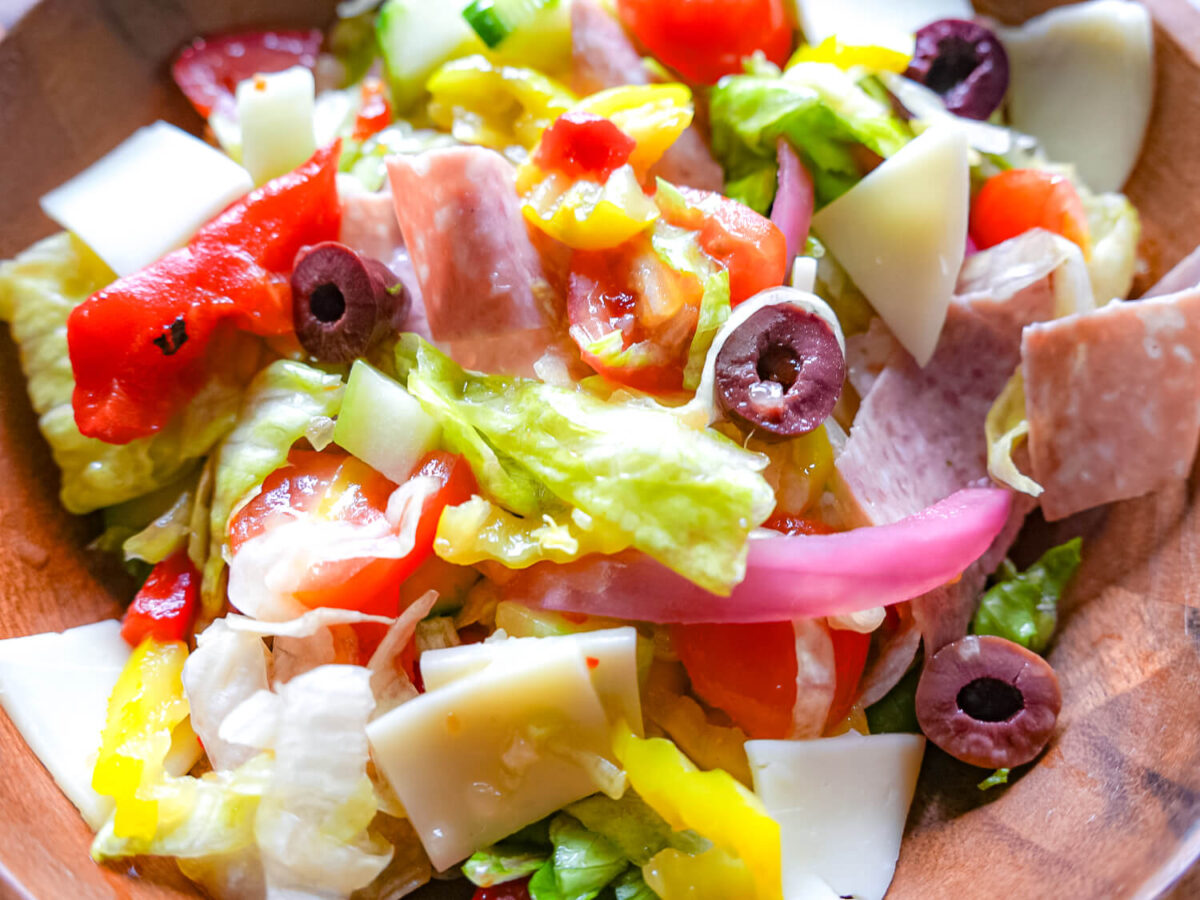 step four photo of tossing salad and placing in a serving bowl