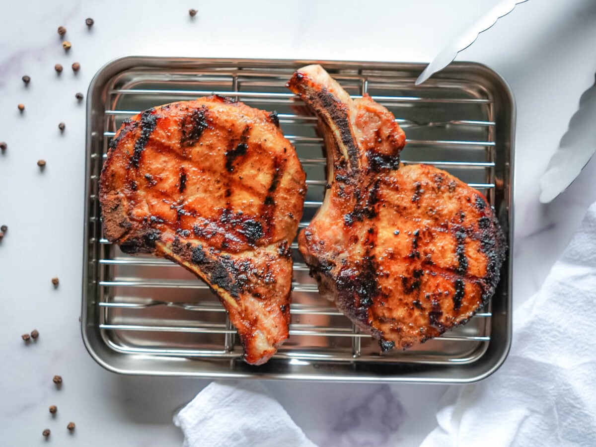 Photo of grilled pork chops on a silver tray