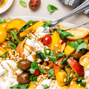 a photo of the Peach Burrata Salad with a fork and spoon
