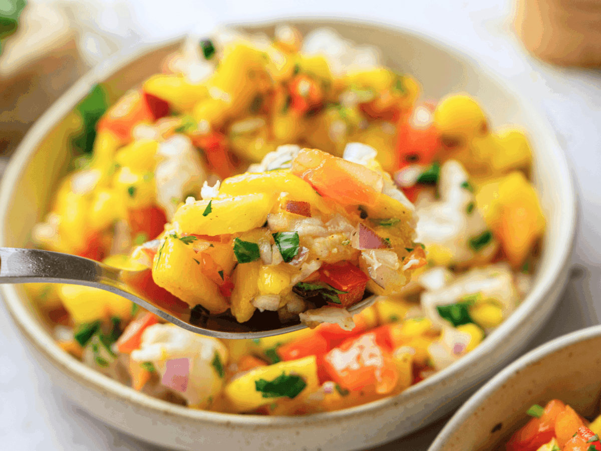 close up spoonful of mango ceviche