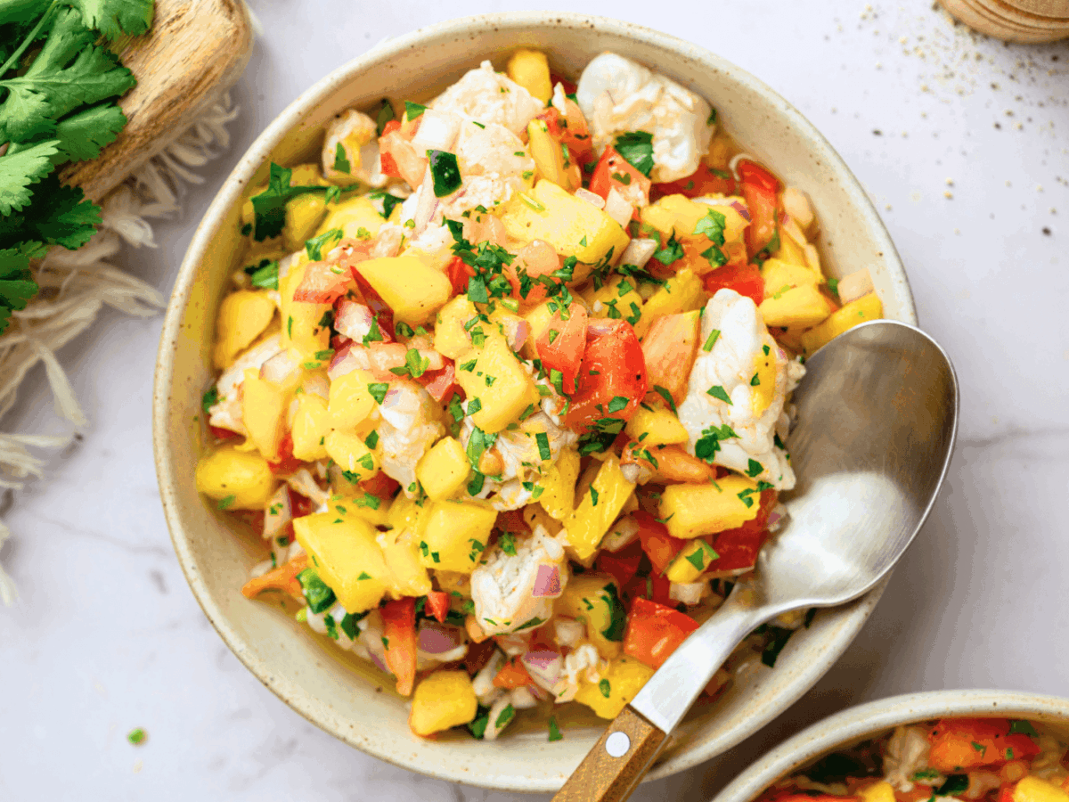 overhead photo of mango ceviche in a bowl with a spoon