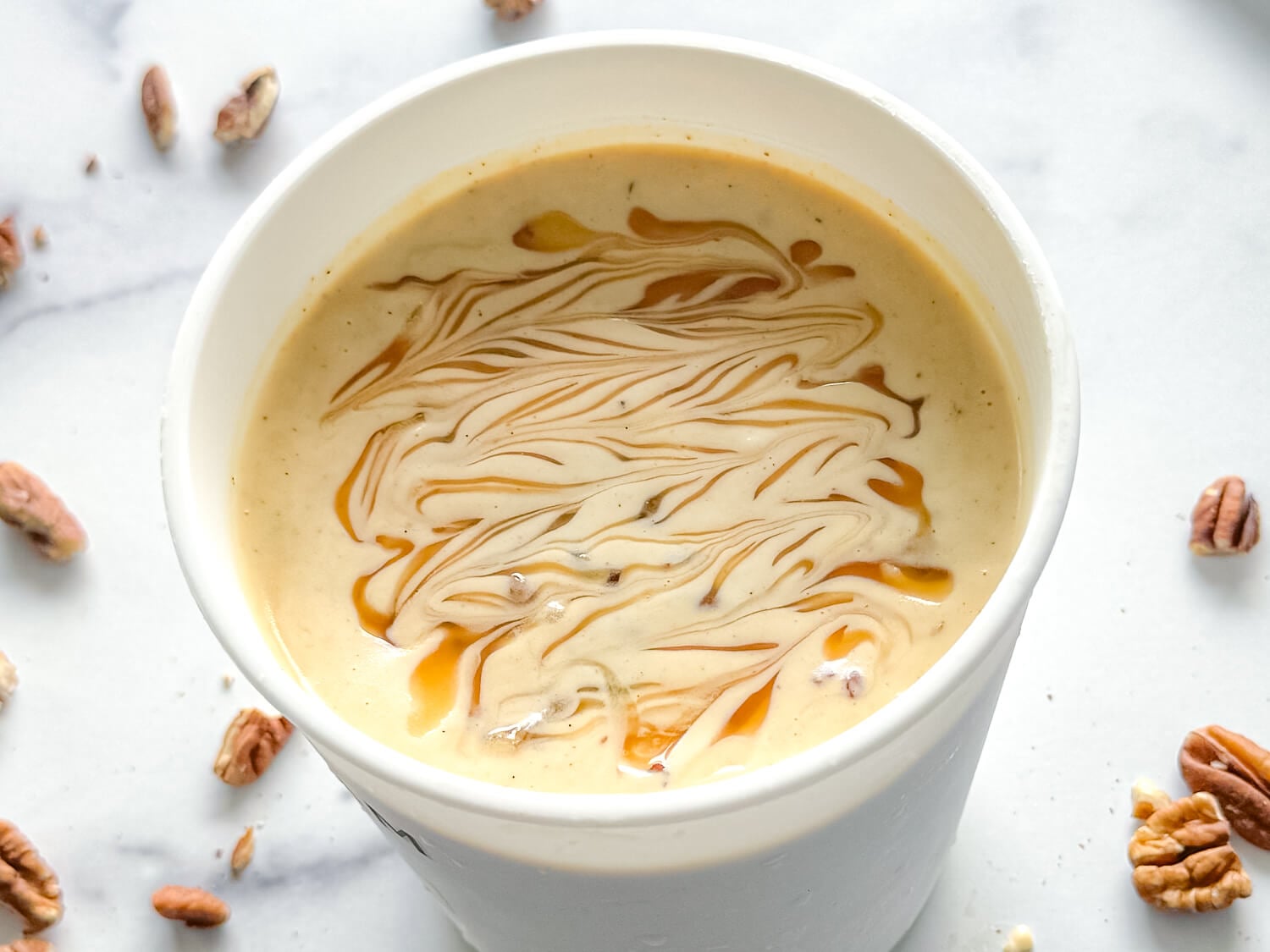overhead photo of praline ice cream with caramel swirls