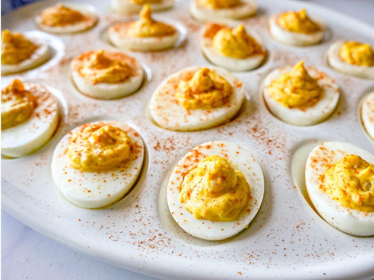 photo of Deviled Eggs on a white tray with paprika on top