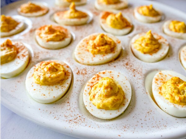 photo of Deviled Eggs on a white tray with paprika on top