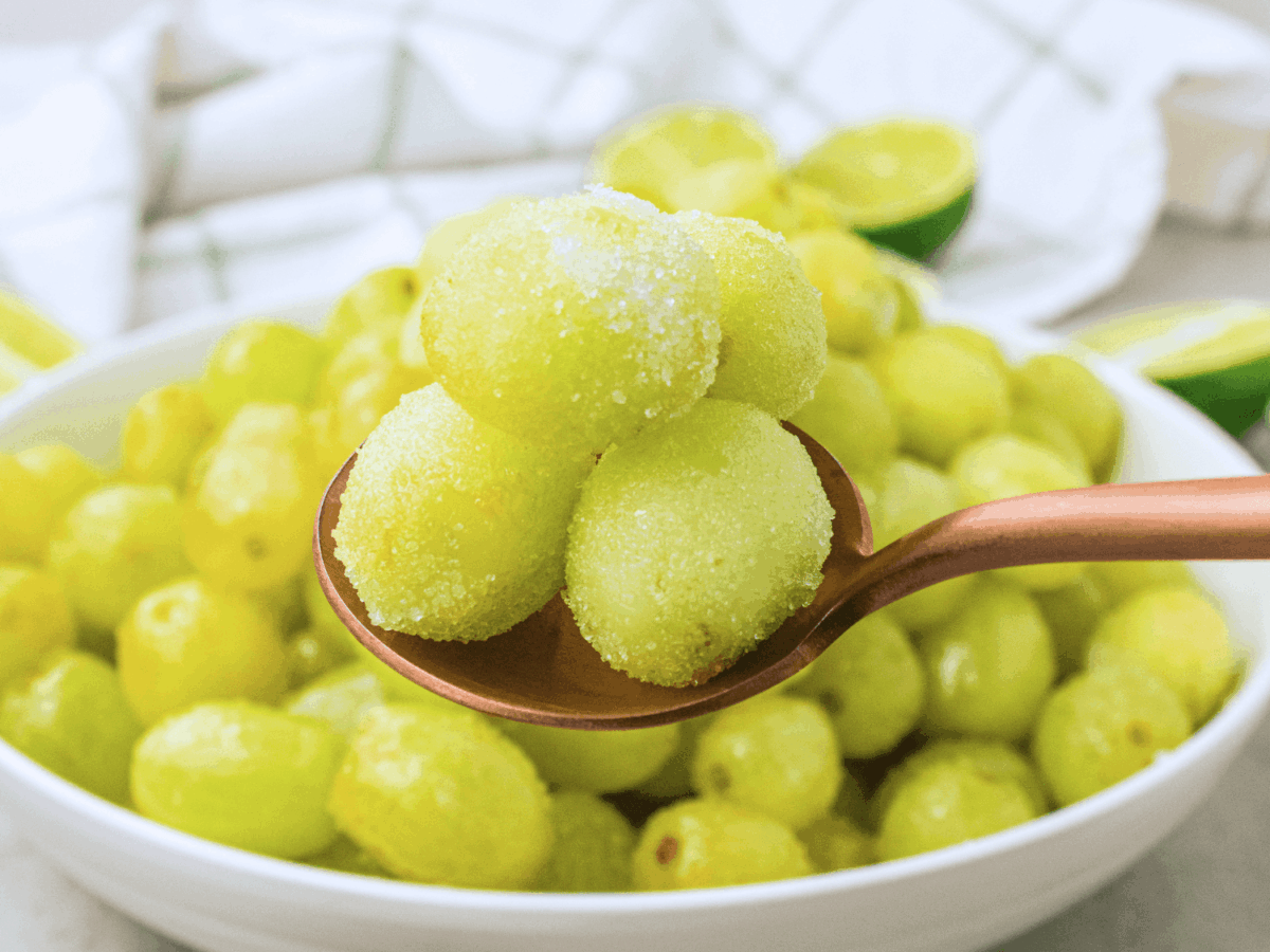 photo of Sour Patch Grapes on a spoon in front of the bowl