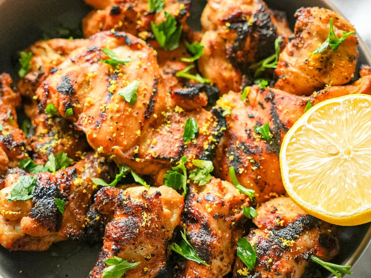 photo of grilled lemon chicken garnished with parsley and lemon zest
