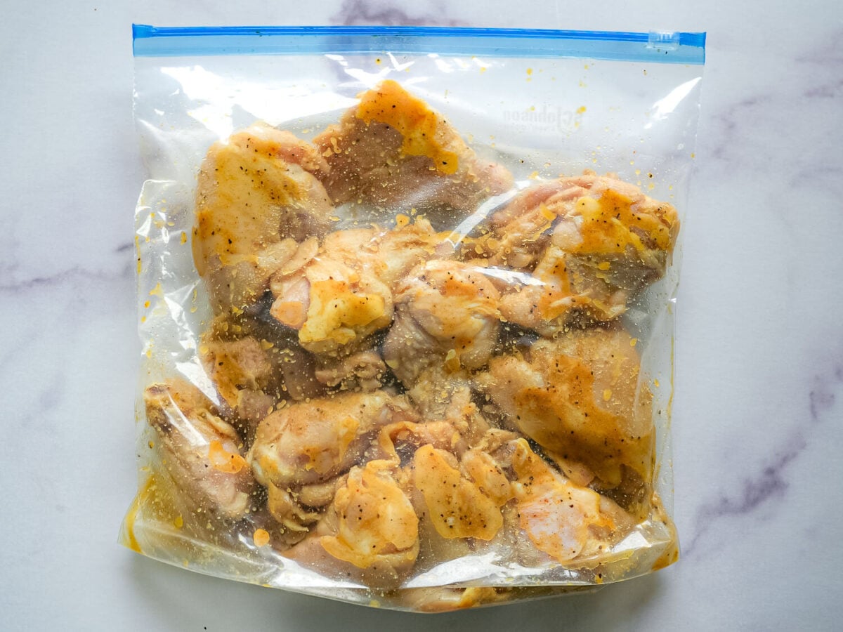 photo of grilled lemon chicken marinating in a plastic bag